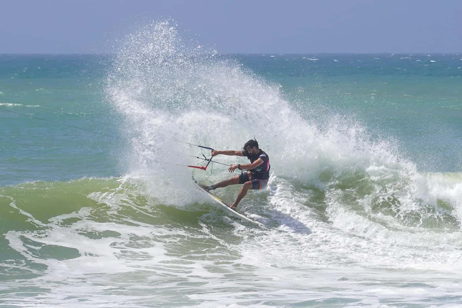 Kitesurfeur prenant une courbe dans une vague qui déferle, type de conditions rencontrées sur le récif de One Eye au Morne